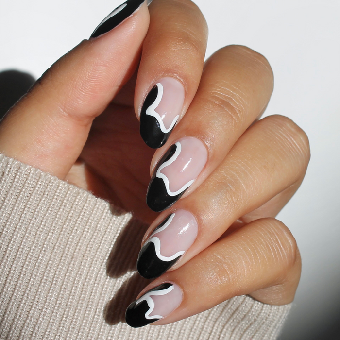 Blank Canvas white liner used for black and white swirl nail art on a sheer nude manicure