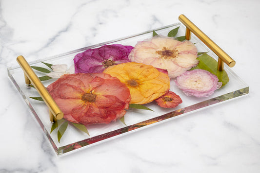 Decorative resin tray with pressed floral design on a marble surface