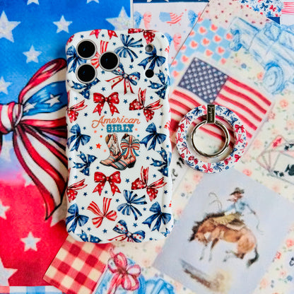 American Girly MagSafe grip ring attached to the matching American Girly iPhone case, styled with an American flag, red gingham and a cowboy illustration.