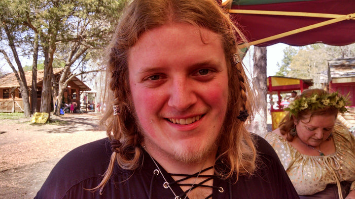 Model wearing Celtic Strength Hair Bead at Renaissance fair, silver Viking braid jewelry