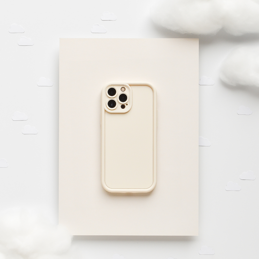 Beige iPhone with a soft, cream-colored Coconut Lane phone case set on fluffy clouds with simple illustrations.