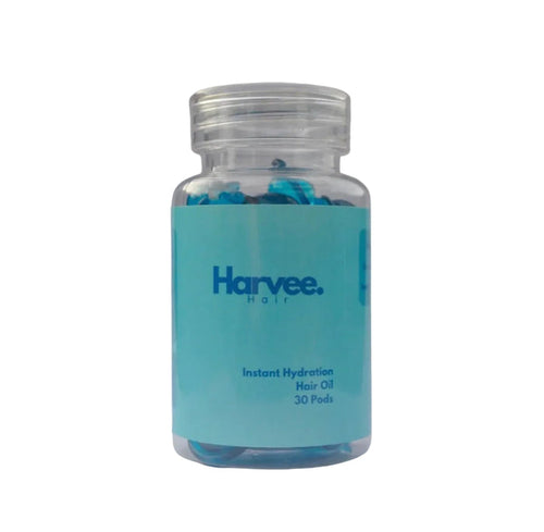 Bottle of Harvee hair oil with a blue label on a white background