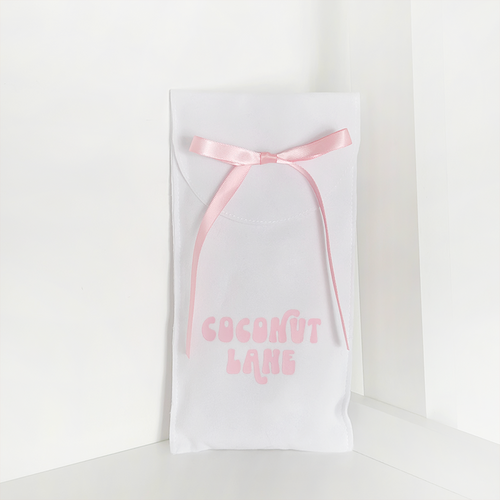 Coconut Lane phone case gift pouch with pink lettering and ribbon on a simple, eco-friendly fabric.