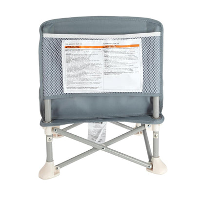 The Nuby Pop Up Booster Seat in grey features a mesh-backrest, safety warning labels, and sturdy metal legs with white plastic feet—perfect as a portable baby seat—shown from the back.