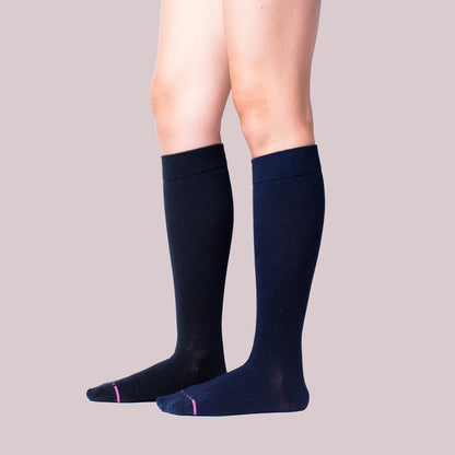 Knee-high compression socks in a solid dark color with contrasting toe detail.