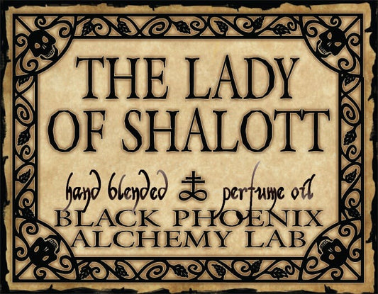 Label for 'The Lady of Shalott' perfume oil by Black Phoenix Alchemy Lab with decorative border.