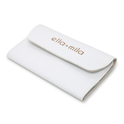 White faux-leather manicure tool case, closed with embossed ella+mila logo