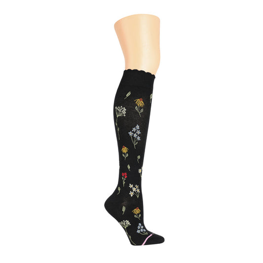 Knee-high black compression socks with colorful wildflower patterns and a scalloped top.