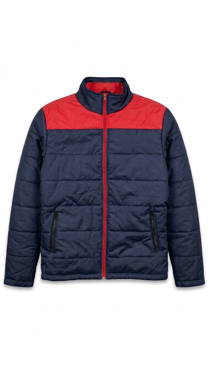 A navy blue puffer jacket with a contrasting red yoke across the chest and collar, featuring a full-length red zipper and zippered hand pockets, shown against a plain white background.